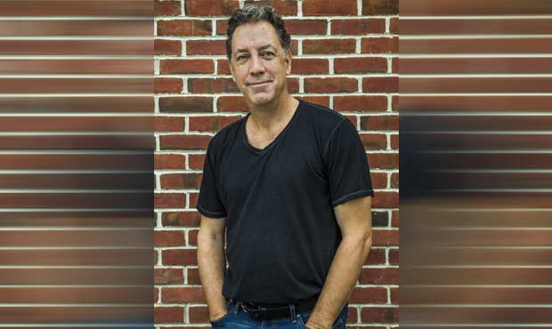 David Gonzalez standing in front of a brick wall with a black t-shirt