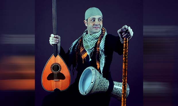 Karim Nagi holding traditional Muslim instruments
