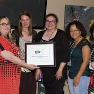 Liz Kuwornu presents an award to teachers from Washington Elementary School in Trenton, NJ
