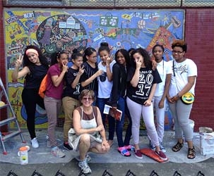 Students form Sussex Ave. Elementery School in front of a mural