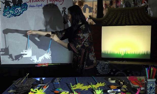 Hua Hua Zhang demonstrating shadow puppetry