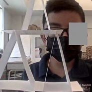 Student creating a sculpture with stacked pieces of paper